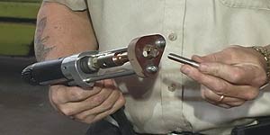 A weld stud fastener is inserted into the stud welder gun